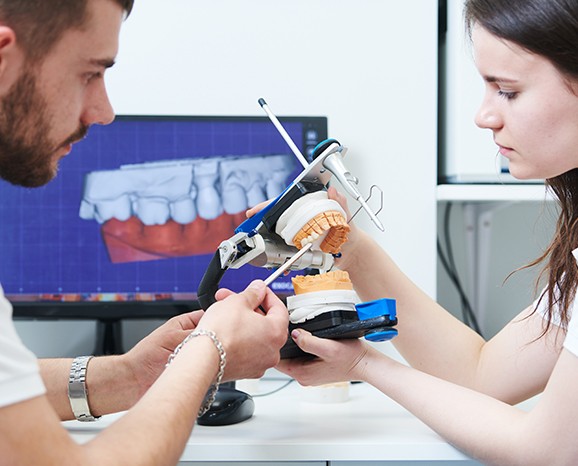 Staff member working with implant model