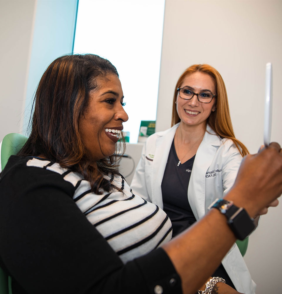 Patient smiling with Dr. after procedure