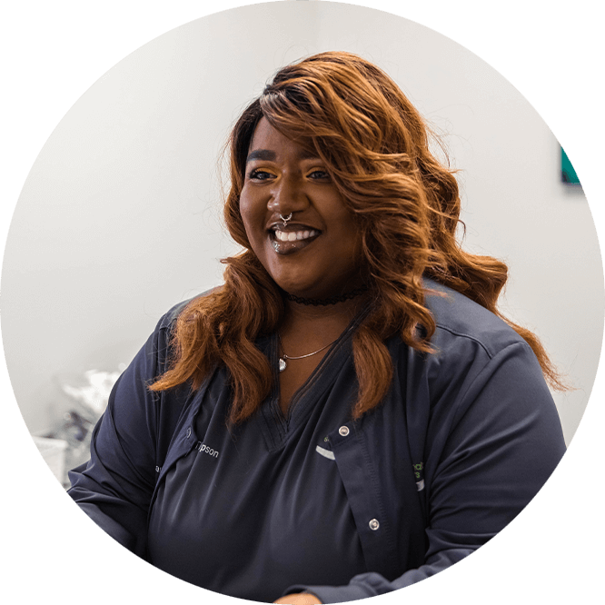 staff member at front desk smiling in the dental practice