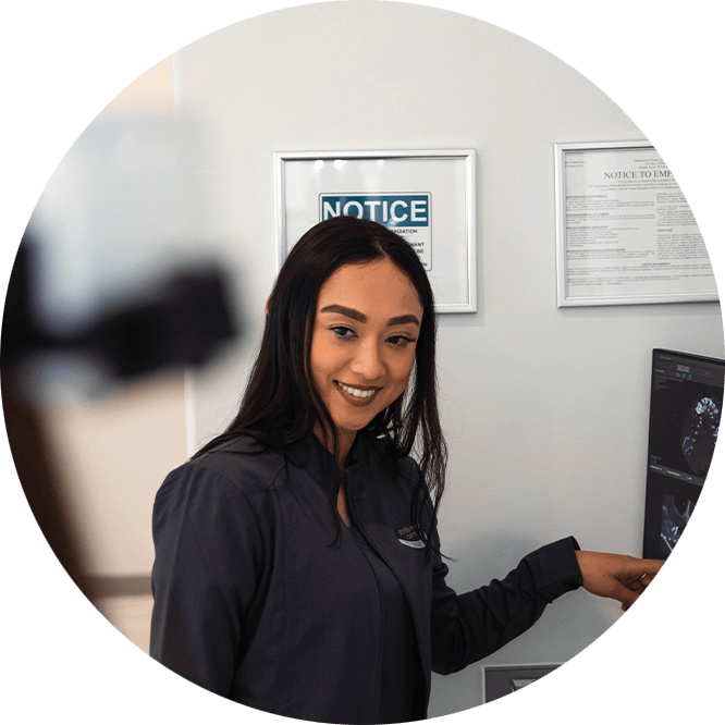 staff member pointing at display of implant graphic