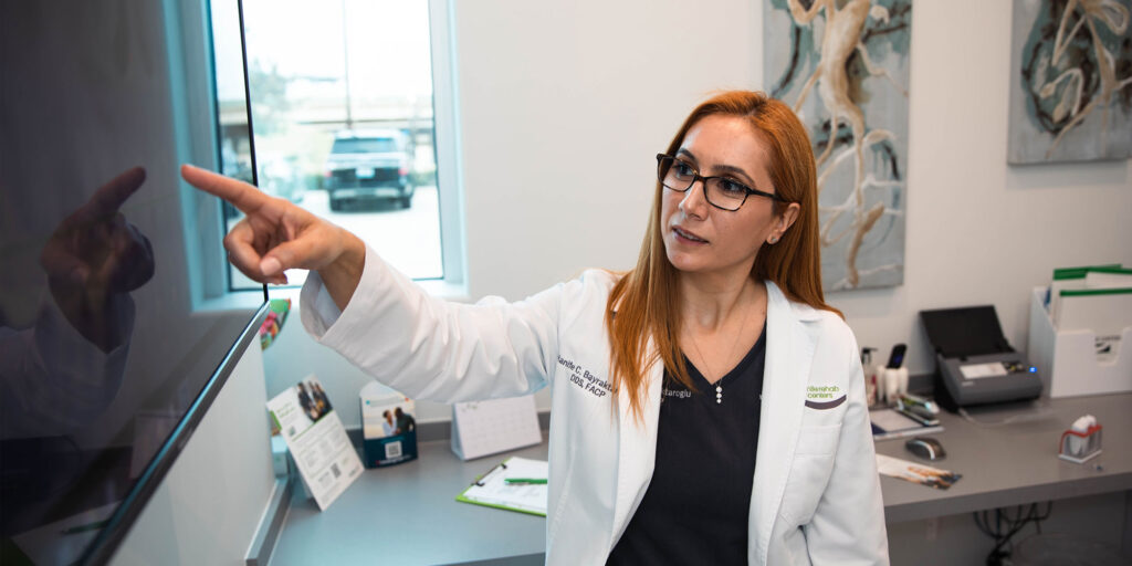 doctor showing a preview of the dental implant procedure